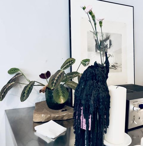 Studio plants beside a black sculpture