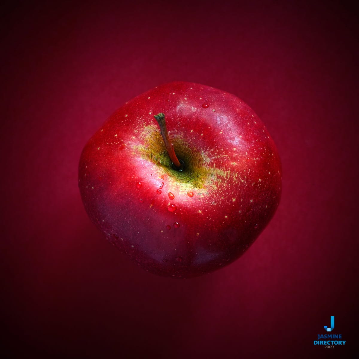 Red apple on red background