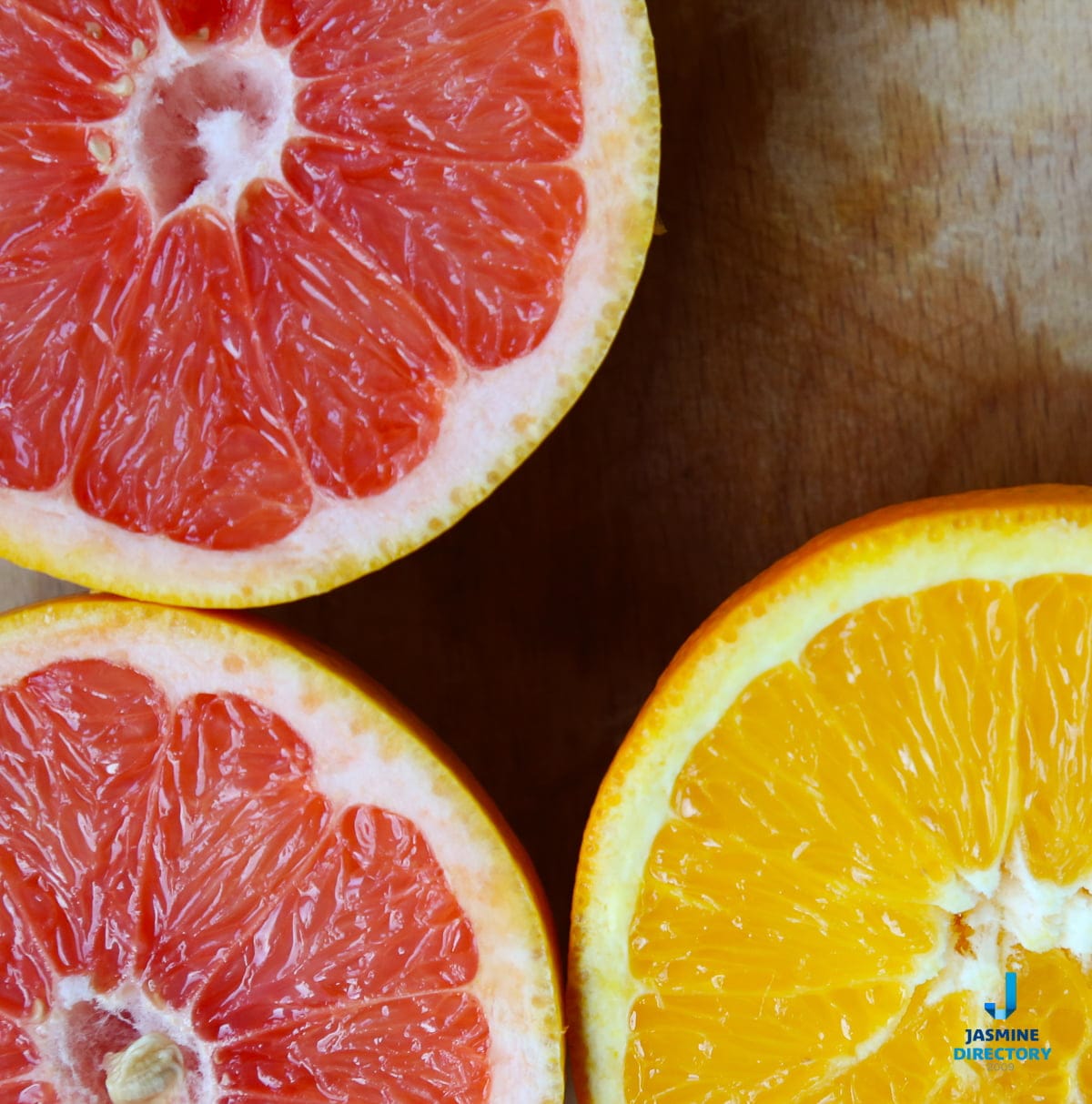 Grapefruit and orange halves on a wooden table