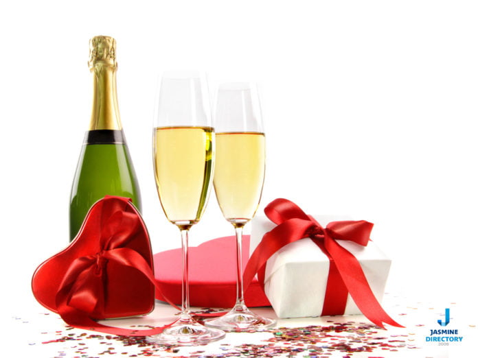 Celebrate Valentine's Day-Glasses of champagne with bottle and gifts on white Champagne - Sparkling wine