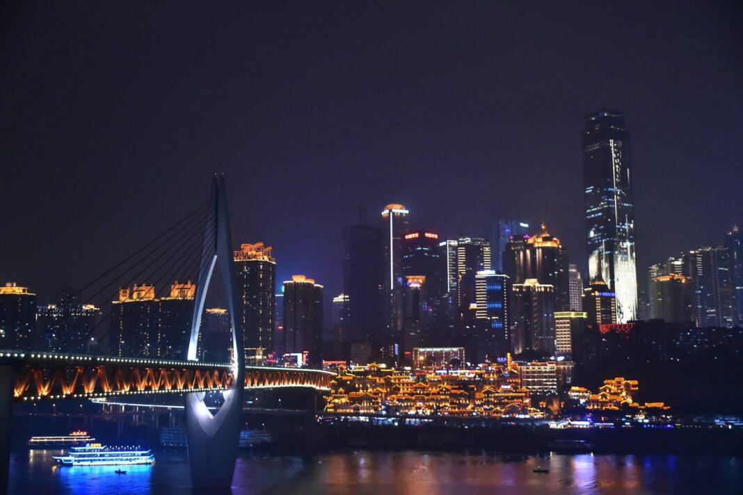 Photo by Lian Rodriguez Lighted Buildings Near River at Night