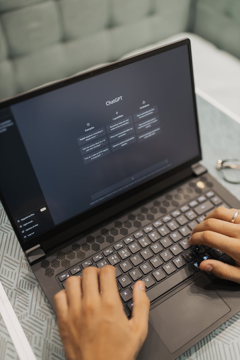 A person typing on a laptop computer