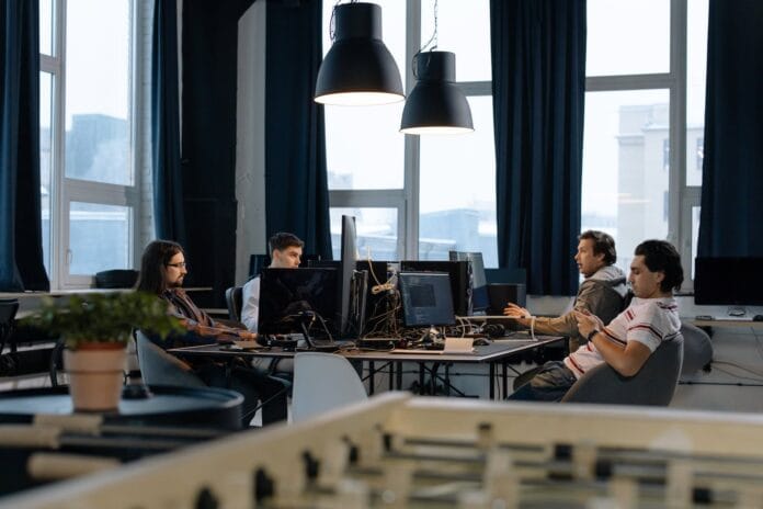 Employees Sitting at Desks in Office