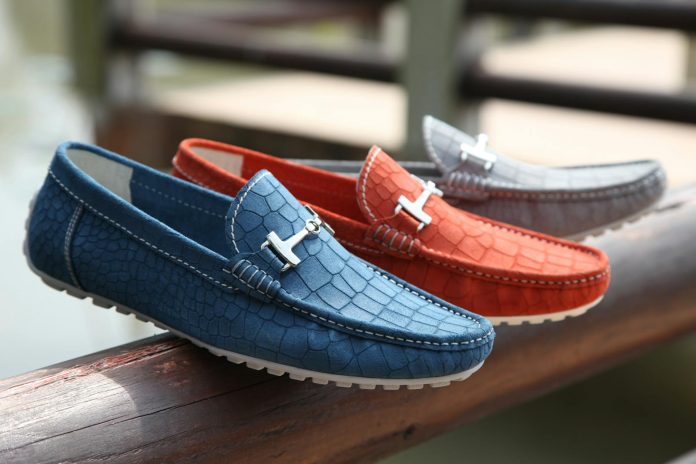 Selective Focus Photography of Three Unpaired Red, Blue, and Gray Leather Horsebit Loafers