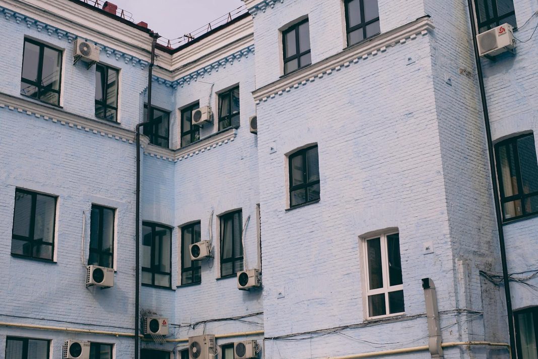 Photo by Maria Orlova Old house exterior with air conditioning units on walls