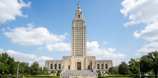 Why Louisiana lawyers use a law firm directory The Louisiana State Capitol Building rises above manicured grounds with a reflecting pool, representing the state's legal infrastructure that law firm directories help navigate.