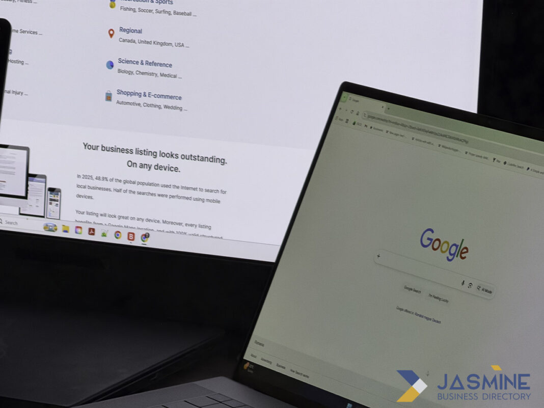 Dual laptop screens showing business directory and search platforms illustrate strategic online listing locations for 2026 Two laptop screens display a business directory website and Google homepage, illustrating platforms where businesses should maintain online listings in 2026.