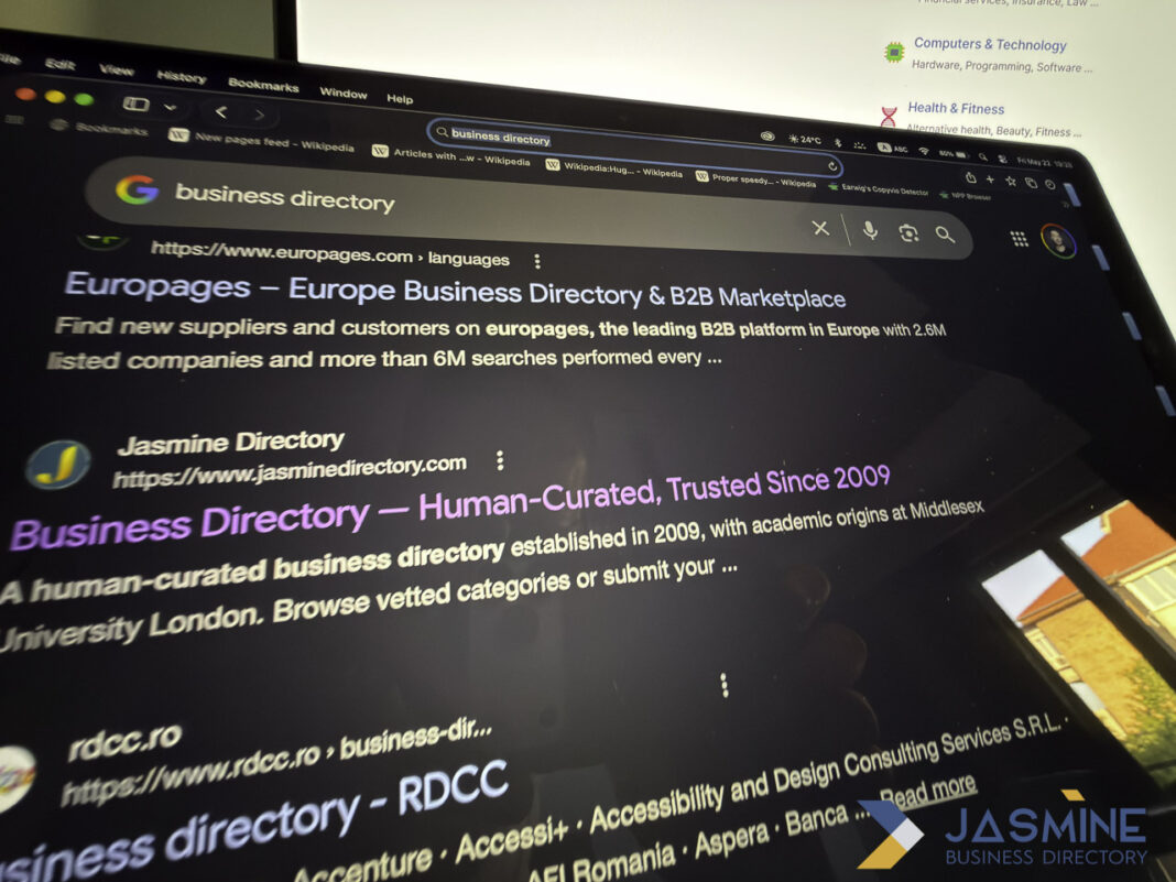 Computer screen showing business directory search results illustrates evaluating online business listing platforms Computer monitor displays Google search results for business directories including Europages and Jasmine Directory, illustrating the research process for selecting quality business listing platforms.