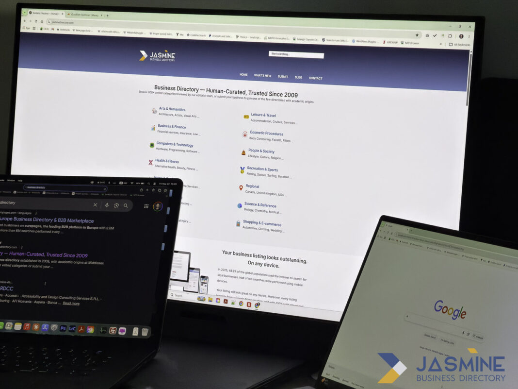 Dual laptop workspace showing online business directory interface for listing professional services Two laptops side by side display a business directory website with search and category pages, illustrating the digital interface for listing law firms in online directories.