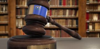 The best law firm directory for Nevada practices Wooden judge's gavel bearing the Nevada state flag on a brass-plaqued base, with law books in the background, representing Nevada legal authority.