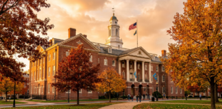 Delaware law firms directory: what to know in 2026 Red-brick colonial building with white cupola and columns surrounded by autumn trees, symbolizing Delaware's enduring legal and corporate institutional framework.