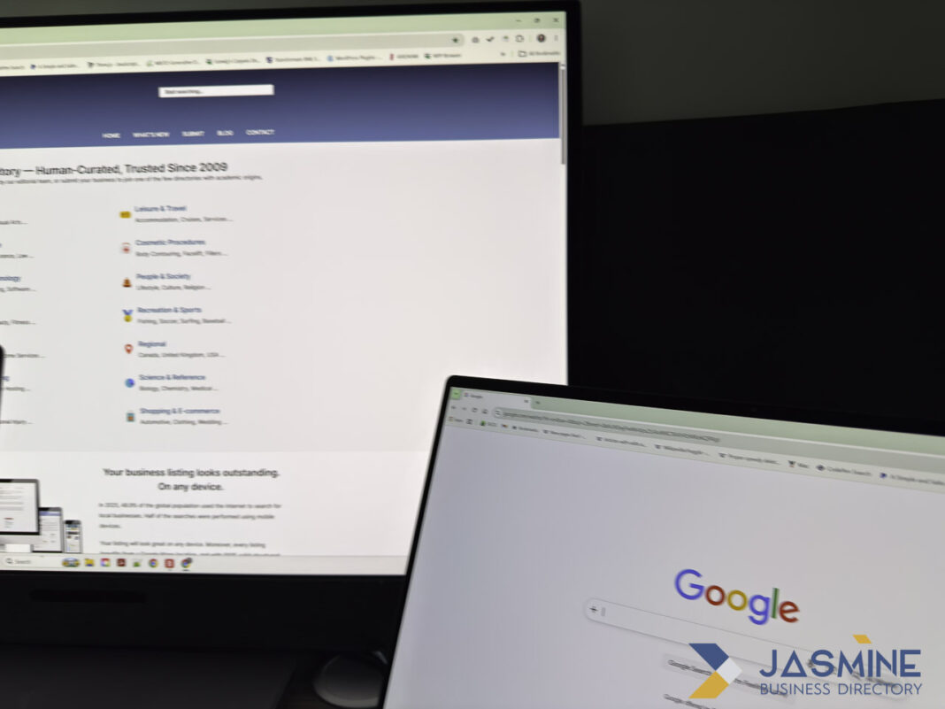 Dual computer screens illustrate the structural differences between online business directories and social media platforms Two computer monitors at an angle display business directory and search websites, illustrating the organized structure of online directories compared to social media.