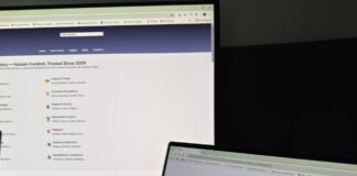 How online directories differ from social media Two computer monitors at an angle display business directory and search websites, illustrating the organized structure of online directories compared to social media.