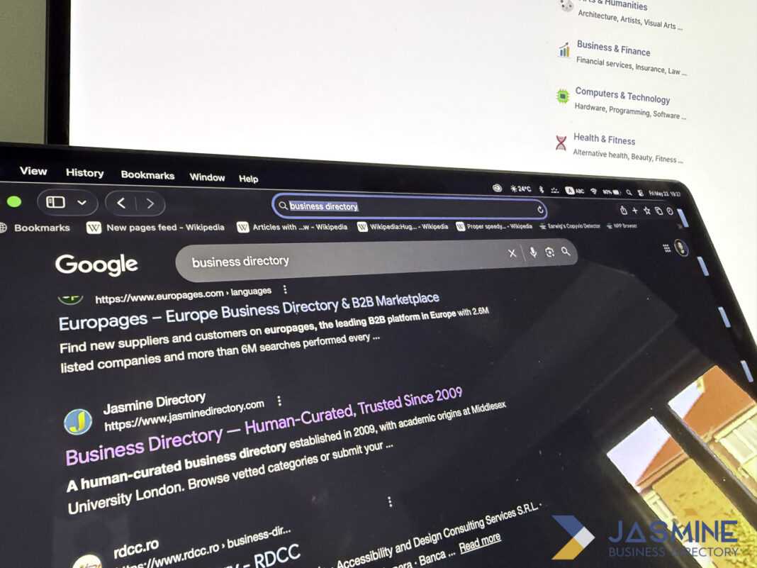 Searching online business directories to list a UK law firm Computer monitor displaying Google search results for business directory with Europages and Jasmine Directory listings, illustrating the process of finding online directories for law firm registration.