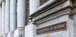 Canadian law firm listings: What clients seek in 2026 Entrance to Quebec Court of Appeal building with bronze plaques on granite pillar and neoclassical columns, representing institutional credibility clients seek when selecting law firms.