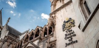 Top legal directories for UK solicitors in 2026 The ornate Gothic Revival facade of the Royal Courts of Justice in London rises against a blue sky, representing institutional authority in UK legal practice.