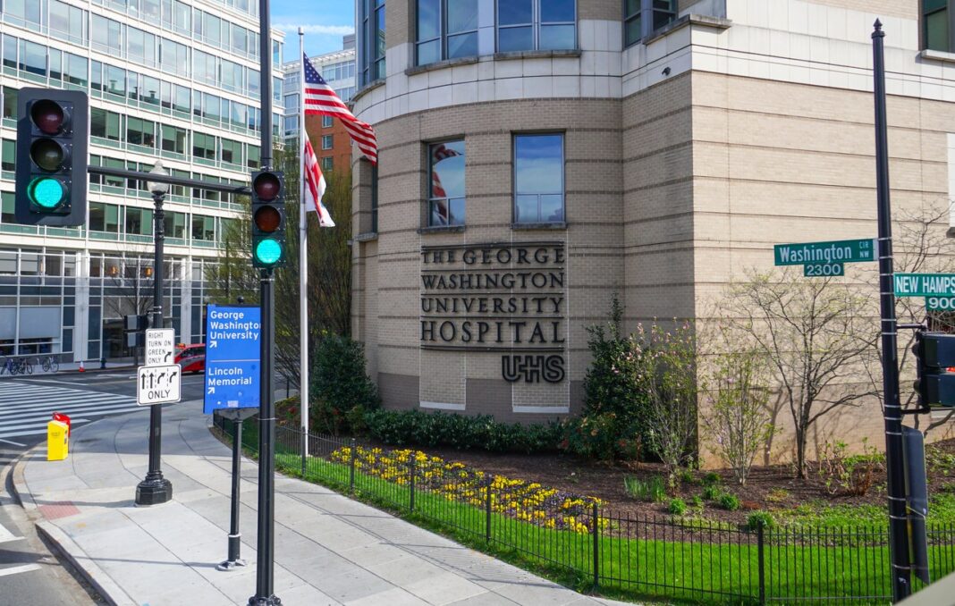Hospital entrance illustrates institutional architecture relevant to professional directory navigation for Washington law firms George Washington University Hospital entrance with blue signage and American flag, illustrating institutional building directory navigation for professional services.