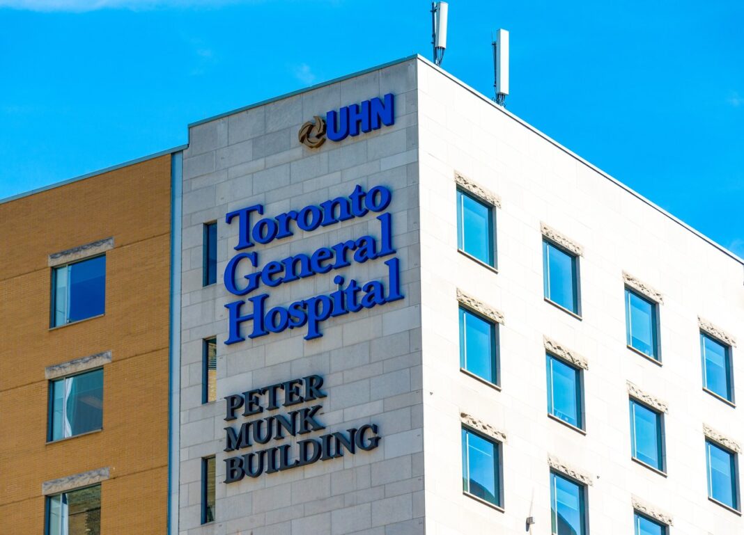 Professional building signage and institutional presence illustrate business visibility principles for Canadian law firms Toronto General Hospital Peter Munk Building exterior with prominent signage and modern facade, demonstrating institutional visibility and professional presence relevant to business directory listings.