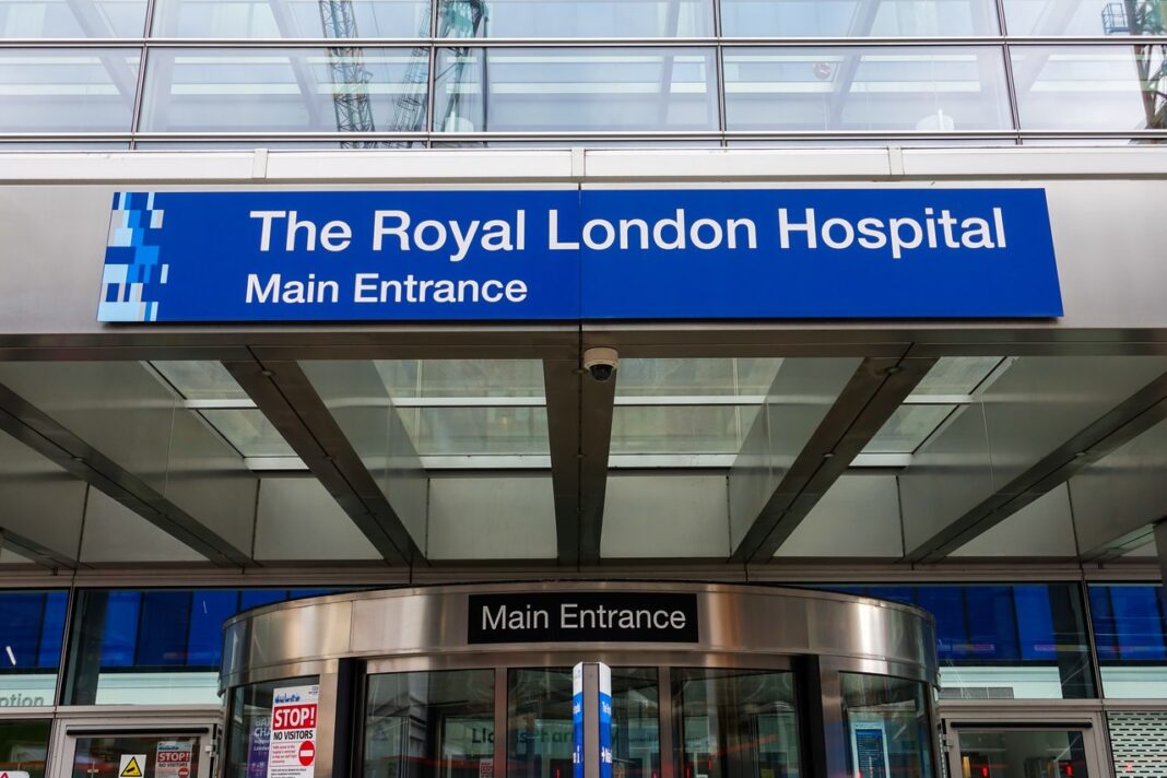 Modern institutional entrance illustrating professional service accessibility expected by UK legal clients in 2026 Modern hospital main entrance with blue signage and glass doors, representing the professional accessibility and transparency clients expect when discovering services.