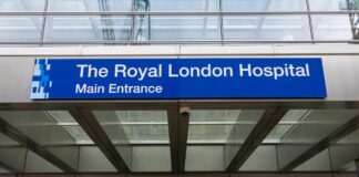 UK Law firm listings: what clients expect in 2026 Modern hospital main entrance with blue signage and glass doors, representing the professional accessibility and transparency clients expect when discovering services.
