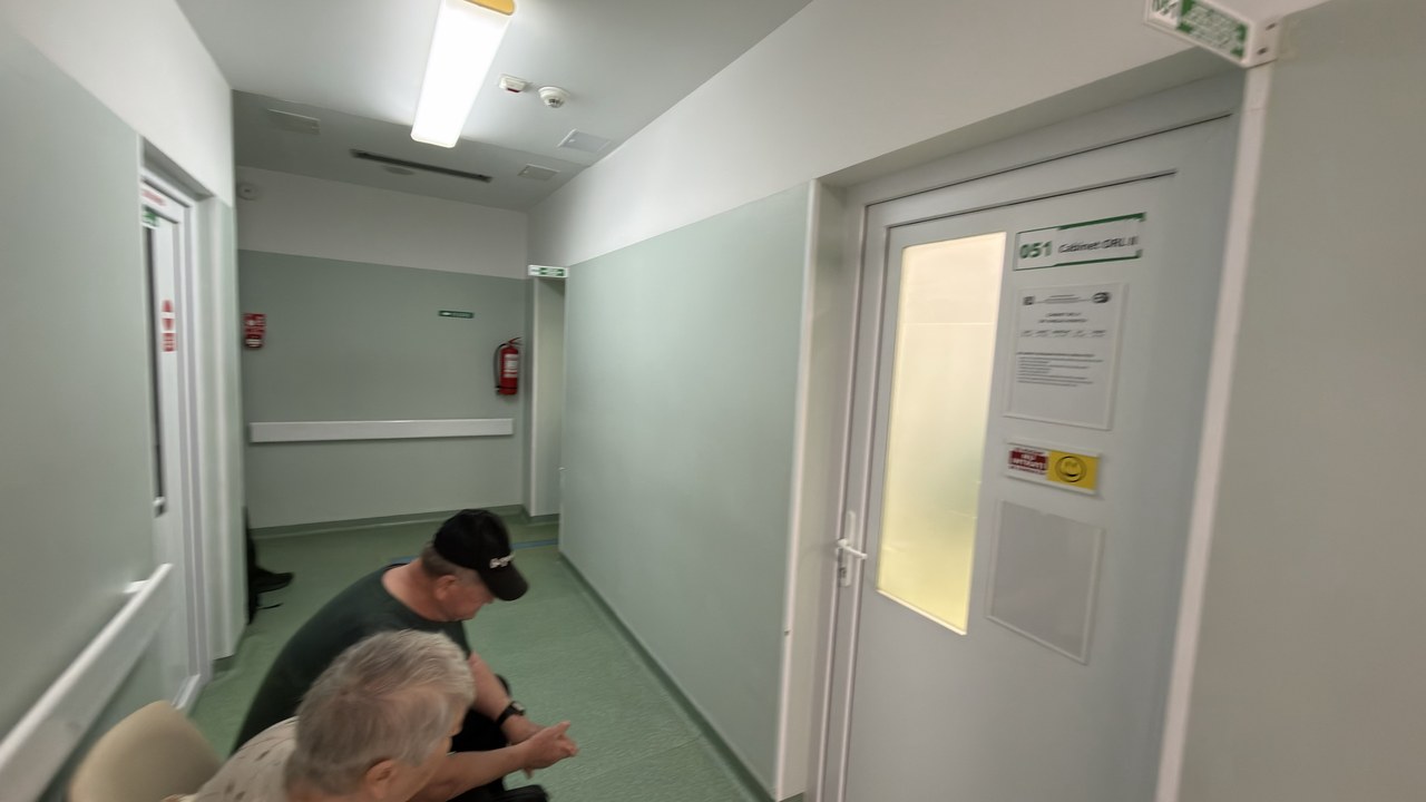 Institutional corridor with two people
