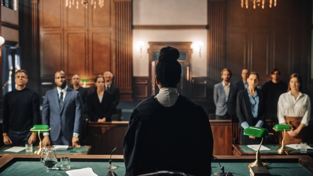 Formal courtroom proceedings illustrate the legal infrastructure supporting Texas law firm directory services Judge in black robes presides over attorneys standing in a traditional wood-paneled courtroom, representing the legal infrastructure accessible through Texas law firm directories.