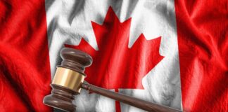 How legal directories send cases to canadian firms Wooden judge's gavel rests on sound block before Canadian flag backdrop, symbolizing the judicial framework supporting law firm directory referral systems in Canada.