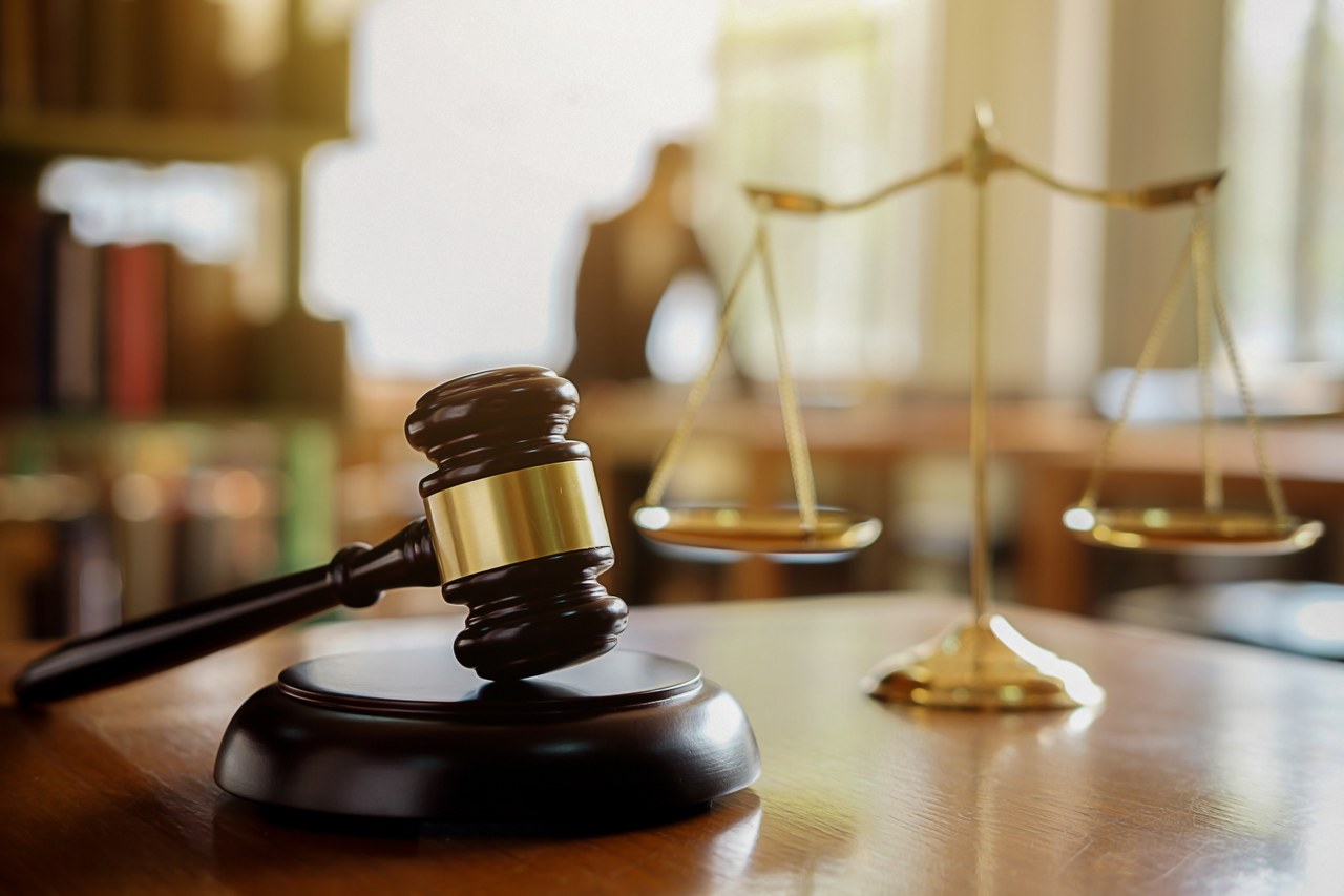 Legal gavel and balance scale on desk