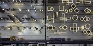 Photos and your business listing: a 2026 guide Organized lighting showroom with illuminated track lights and LED fixtures on wall displays, exemplifying professional business listing photography for retail establishments.