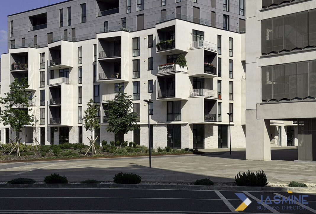 Modern apartment building exemplifies real estate properties featured in online directories Modern apartment building with white balconies and commercial ground floor in Timișoara, representing the type of property featured in real estate online directories.