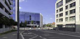 How Georgia firms benefit from a law firm directory Wide intersection in a modern business district with contemporary glass office buildings and paved streets, representing the professional commercial environment where law firms establish their presence.