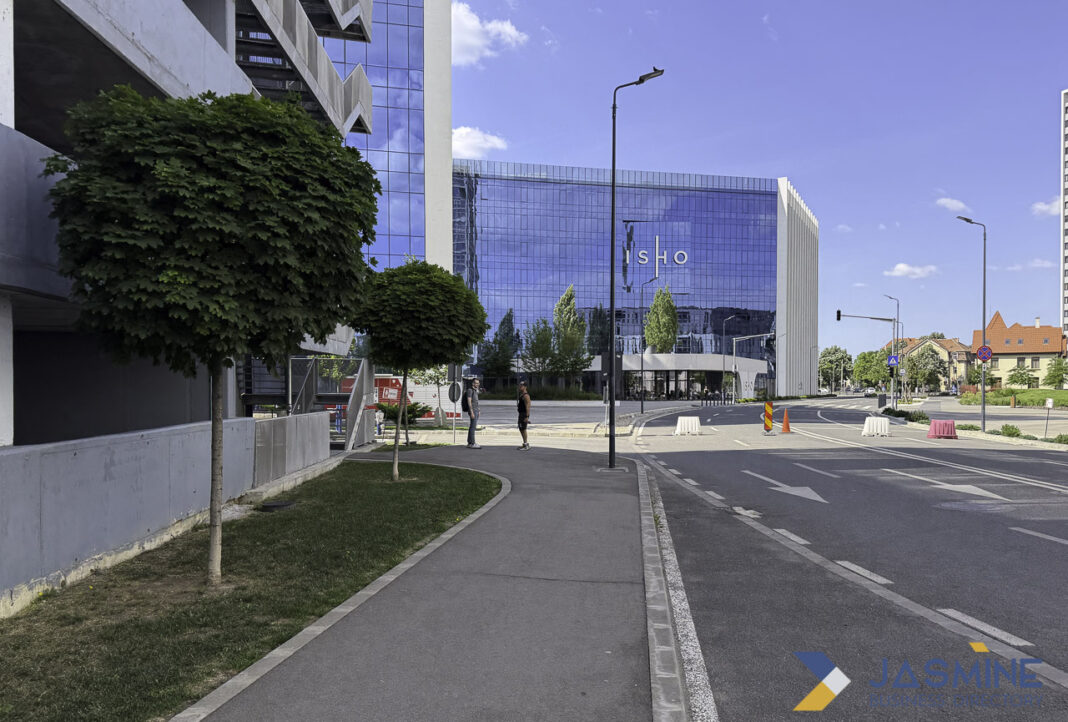 Modern commercial building exemplifies professional business presence and discoverability in urban setting Modern blue glass business center with clear signage in an urban plaza, illustrating the importance of visible and accessible business locations for customer discovery.