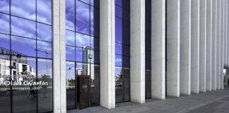A 2026 look at the Massachusetts law firm directories Modern glass and concrete office building entrance with reflective facade, representing contemporary professional and legal business infrastructure in urban commercial districts.
