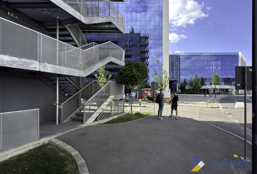 Modern corporate business district architecture illustrates professional infrastructure supporting Michigan law firm discovery Contemporary glass office buildings in a modern business district with pedestrians, illustrating the professional infrastructure where law firms operate and connect with clients.
