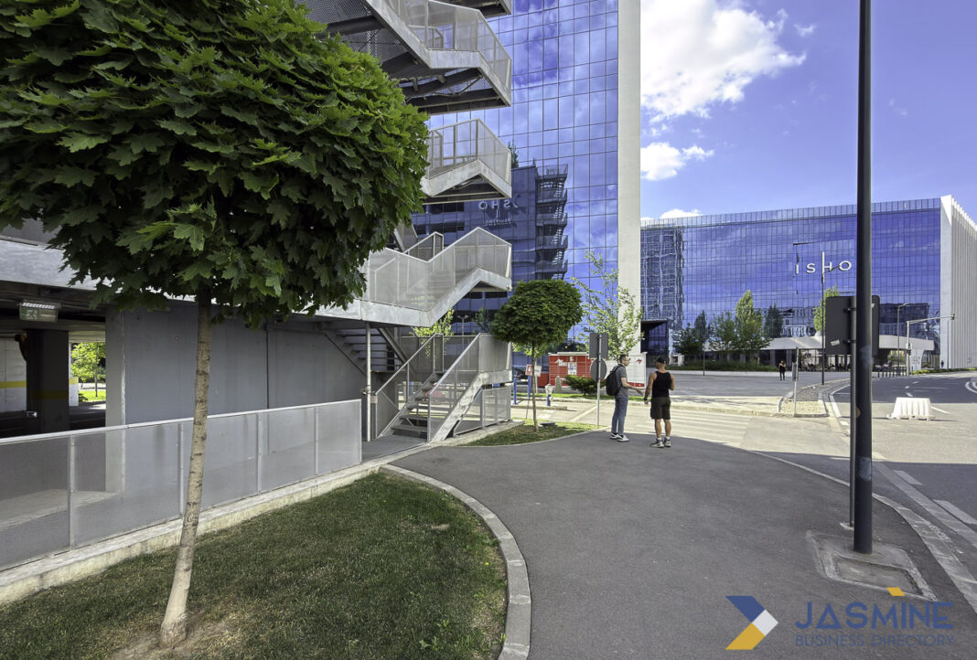 Modern business district architecture illustrating professional infrastructure for Australian business directory listings Modern glass office towers behind landscaped plaza with pedestrians, representing professional business infrastructure featured in directories.