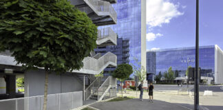 The best Australian business directories in 2026 Modern glass office towers behind landscaped plaza with pedestrians, representing professional business infrastructure featured in directories.