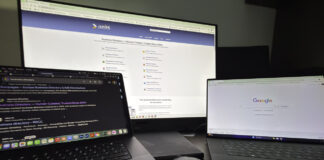 The 2026 web directory submission guide Three-screen computer workstation with MacBook, external monitor displaying business directory website, and laptop showing Google homepage, illustrating the digital setup used for web directory submission work.