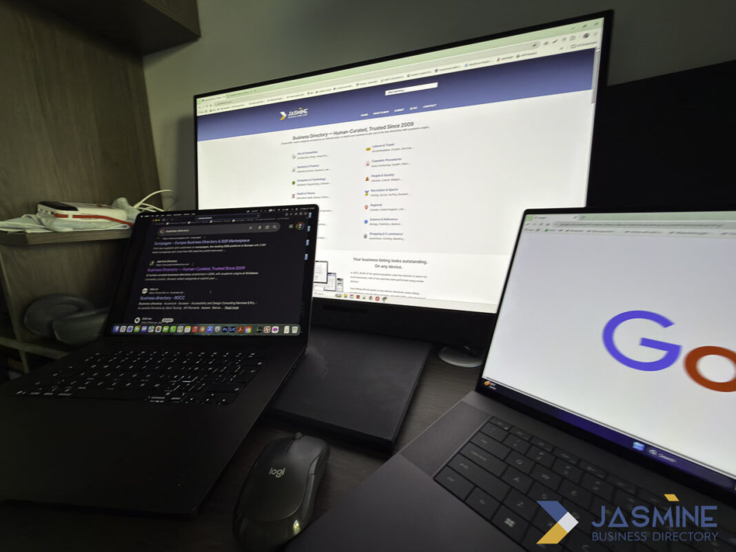 Multi-monitor computer setup illustrating digital tools for maintaining business listings and online presence Three-screen computer workstation displays business directory website on central monitor with laptops on either side, demonstrating tools used for managing and updating business listings.