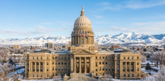 Law firms in Wyoming Neoclassical capitol building with golden dome and columned entrance in winter, representing governmental and legal institutional architecture for Wyoming law firm directory context.