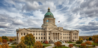 List your practice in the South Dakota law firm directory Neoclassical state capitol building with green copper dome surrounded by autumn trees, representing governmental authority for law firm directory inclusion.