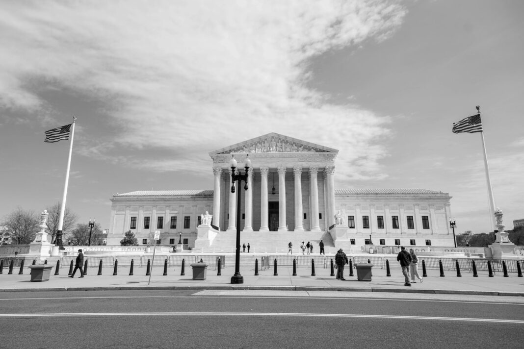 Supreme Court building exemplifies institutional architecture featured in national law firm directory guide Neoclassical Supreme Court building with Corinthian columns and American flags, representing the institutional legal framework supporting national law firm directories.