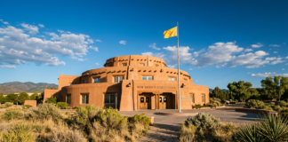 Are you looking for a New Mexico law firm directory? The New Mexico State Capitol building in Pueblo Revival style under blue sky, representing the state's governmental and legal professional infrastructure.