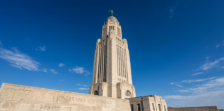 How a Nebraska law firm directory works The Nebraska State Capitol's Art Deco tower rises against a blue sky, symbolizing the state's legal infrastructure and resources accessible through the law firm directory.