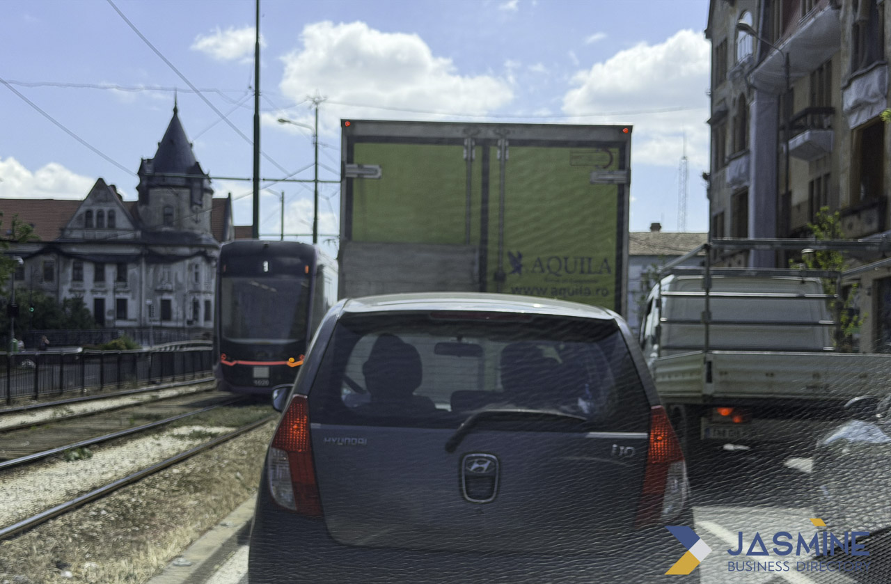 Traffic scene with Hyundai i10 and delivery truck
