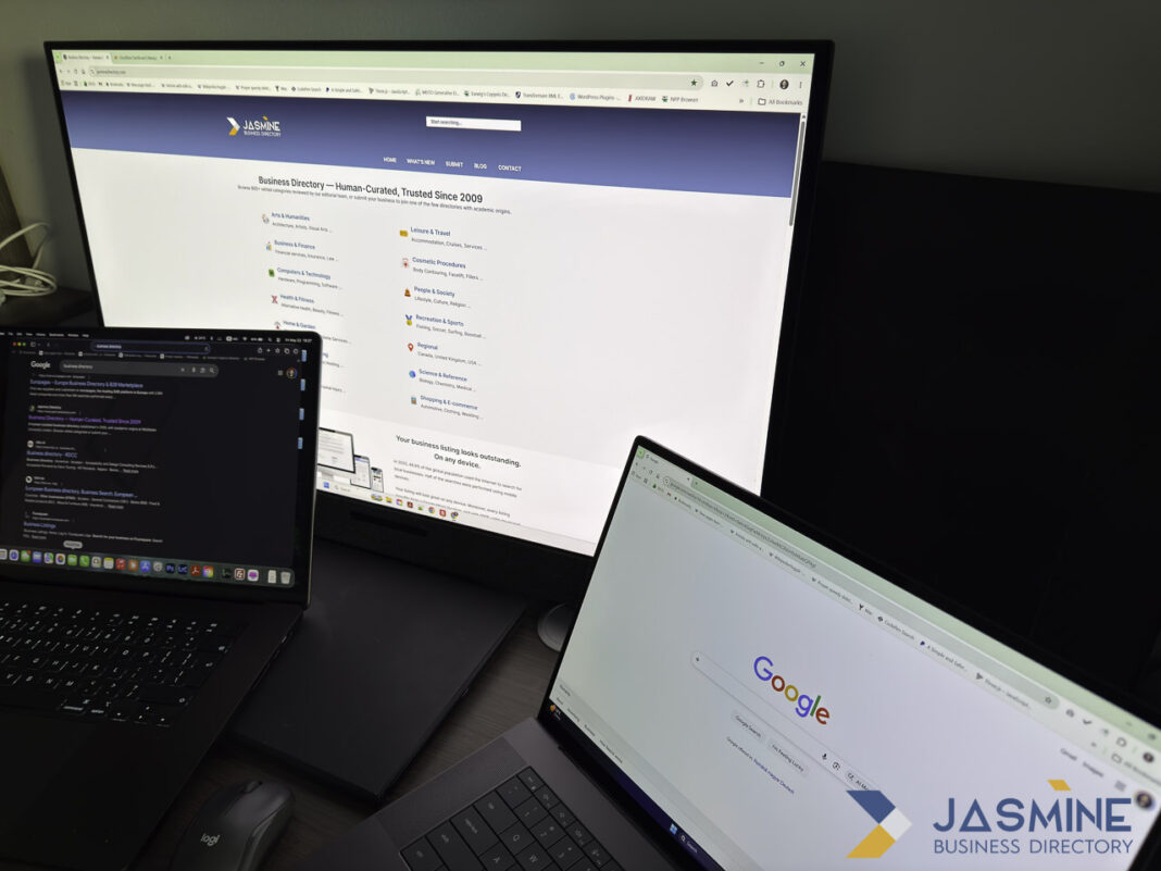 Dual laptop setup illustrates the challenge of managing business listings across multiple online directories and platforms Two laptop computers display different business directory websites on their screens, illustrating the need to maintain consistent business information across multiple online platforms.