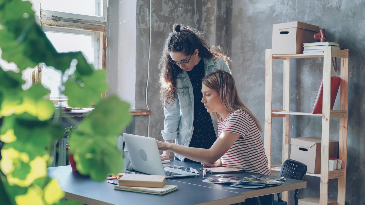 Two women collaborating at workspace