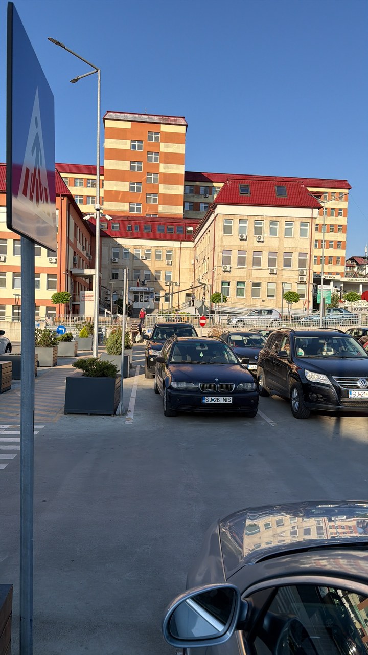 Urban street intersection with vehicles and multi-story buildings
