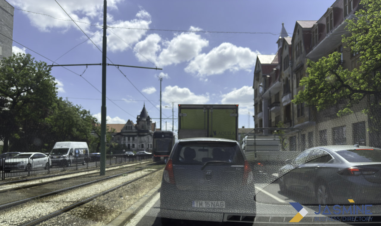 Urban traffic scene with vehicles and tram infrastructure