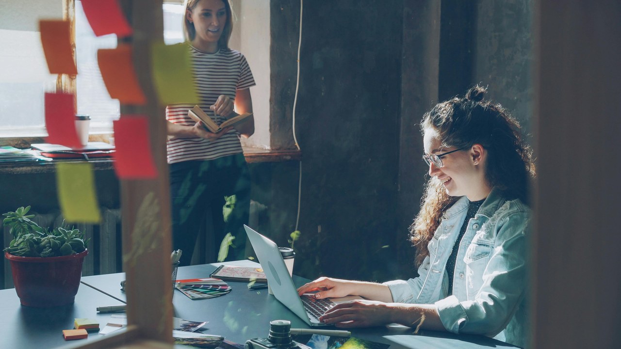 Woman working at desk with laptop