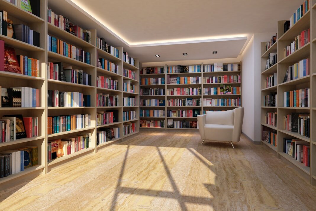 Organized Knowledge Systems Illustrate Editorial Curation for AI Search Visibility Modern home library with floor-to-ceiling bookshelves and white armchair exemplifies the organized curation and structured knowledge systems that enhance search discoverability.